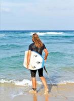 handsome surfer man on the beach photo