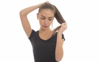 Young attractive smiling woman holding her strong hair and smiling shampoo concept isolated on white photo