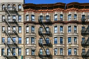 View of old apartment buildings and fire escapes in New York City photo