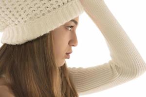 young smiling happy pretty blond woman wearing white knitted sweater and hat, warm winter cold season fashion accessories trend, posing on white studio background isolated photo