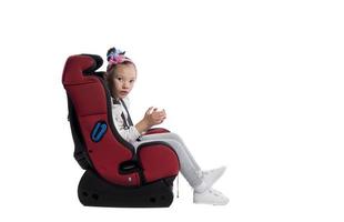 A little girl in a car seat photo