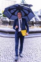 Cheerful Asian businessman in formal wear in the city photo