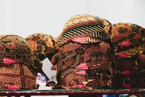 Piles of blangkon sold at a souvenir shop in Jogjakarta. The blangkon is a men's cover or headband in the Javanese traditional dress tradition. photo