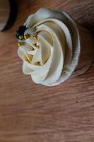 Luxurious and elegant cupcakes, with white cream and navy blue with gold sprinkles. photo