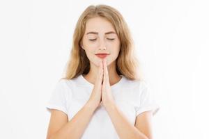 Praying girl isolated on white background. Young woman prayer. Copy space. Make a wish and dream big concept. Faith hope love gesture. Gods blessing photo