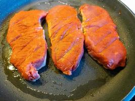 a freshly fried beef steak from the frying pan with delicious ingredients photo