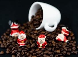 Santa Claus is sitting amid brown roasted coffee beans photo