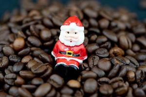 Santa Claus is sitting amid brown roasted coffee beans photo