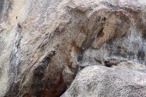 Close up view at a granite and stone wall texture in a high resolution. photo