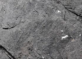 Close up view at a granite and stone wall texture in a high resolution. photo