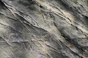 Close up view at a granite and stone wall texture in a high resolution. photo