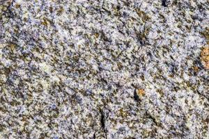 Close up view at a granite and stone wall texture in a hires photo