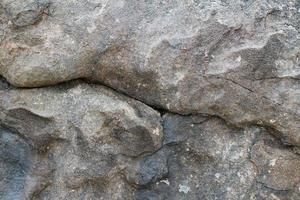 vista de cerca en una textura de pared de granito y piedra en alta resolución. foto