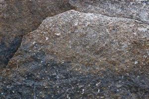 vista de cerca en una textura de pared de granito y piedra en alta resolución. foto