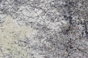 Close up view at a granite and stone wall texture in a high resolution. photo