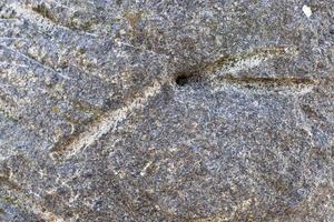 Close up view at a granite and stone wall texture in a high resolution. photo