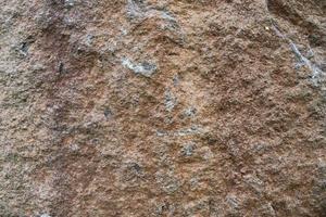 Close up view at a granite and stone wall texture in a high resolution. photo