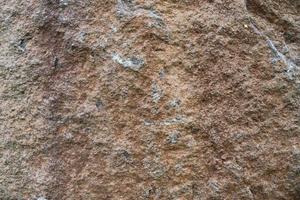 Close up view at a granite and stone wall texture in a high resolution. photo