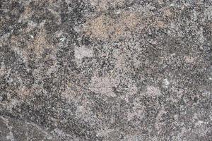 Close up view at a granite and stone wall texture in a high resolution. photo