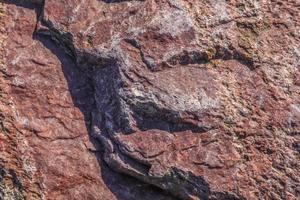 Close up view at a granite and stone wall texture in a hires photo