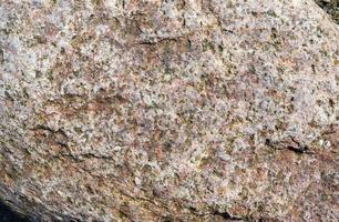 Close up view at a granite and stone wall texture in a high resolution. photo