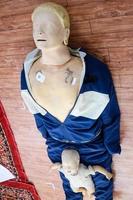 Human dummy lies on the floor during first Aid Training - Cardiopulmonary resuscitation. First aid course on CPR dummy, CPR First Aid Training Concept photo