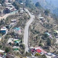 Aerial top view of traffic vehicles driving at mountains roads at Nainital, Uttarakhand, India, View from the top side of mountain for movement of traffic vehicles photo