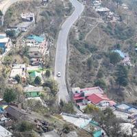 Aerial top view of traffic vehicles driving at mountains roads at Nainital, Uttarakhand, India, View from the top side of mountain for movement of traffic vehicles photo