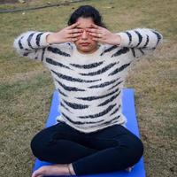 Young Indian woman practicing yoga outdoor in a park. Beautiful girl practice basic yoga pose. Calmness and relax, female happiness. Basic Yoga Exercise outdoor photo