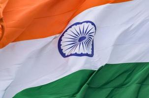 India flag flying high at Connaught Place with pride in blue sky, India flag fluttering, Indian Flag on Independence Day and Republic Day of India, tilt up shot, Waving Indian flag, Har Ghar Tiranga photo