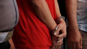 Man handcuffed hands. Prisoner or arrested. photo