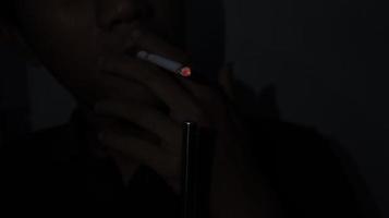 Smoker Lighting a Cigarette with a Gas Lighter. photo