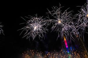 New year celebrate,  crowd and colorful fireworks near the river, Thailand photo