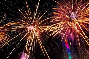 New year celebrate,  crowd and colorful fireworks near the river, Thailand photo