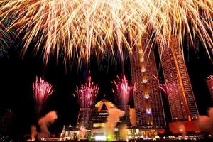 New year celebrate,  crowd and colorful fireworks near the river, Thailand photo