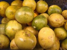 Orange fruit - large amounts of orange fruit, fresh orange fruit, orange fruit in a basket. lemon fruit photo