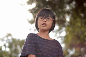 Portrait of child wearing eyeglasses with blur background. photo