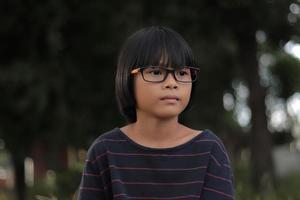 Portrait of child wearing eyeglasses with blur background. photo