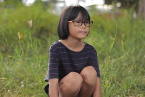 Portrait of child wearing eyeglasses with blur background. photo