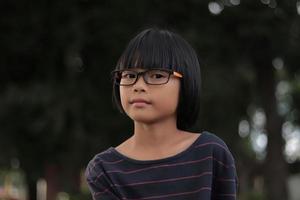 Portrait of child wearing eyeglasses with blur background. photo