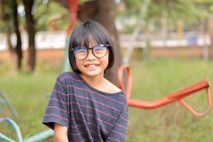 Portrait of child wearing eyeglasses with blur background. photo