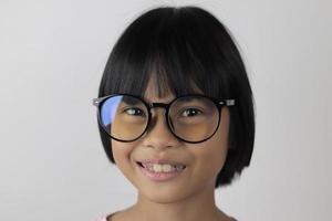 Portrait of child wearing eyeglasses on white background. photo