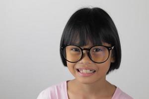 Portrait of child wearing eyeglasses with white background photo