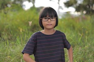 Portrait of child wearing eyeglasses with blur background photo