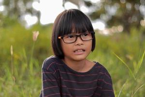 Portrait of child wearing eyeglasses with blur background photo