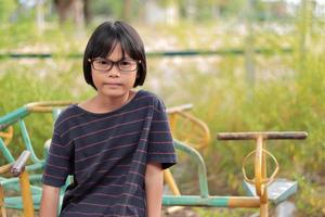 Portrait of child wearing eyeglasses with blur background photo