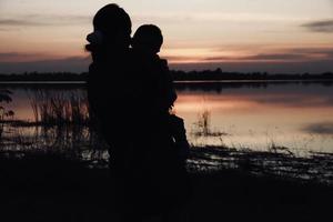 Silhouette of people at sunset photo