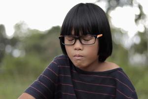 Portrait of child wearing eyeglasses with blur background. photo