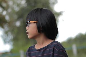 Portrait of child wearing eyeglasses with blur background. photo