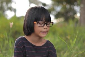 retrato de niño usando anteojos con fondo borroso foto